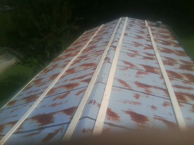 Rusted metal roof panels with new wood purlins before replacement — Storm Damage Roof Repair in Hailey by Roofing Brothers