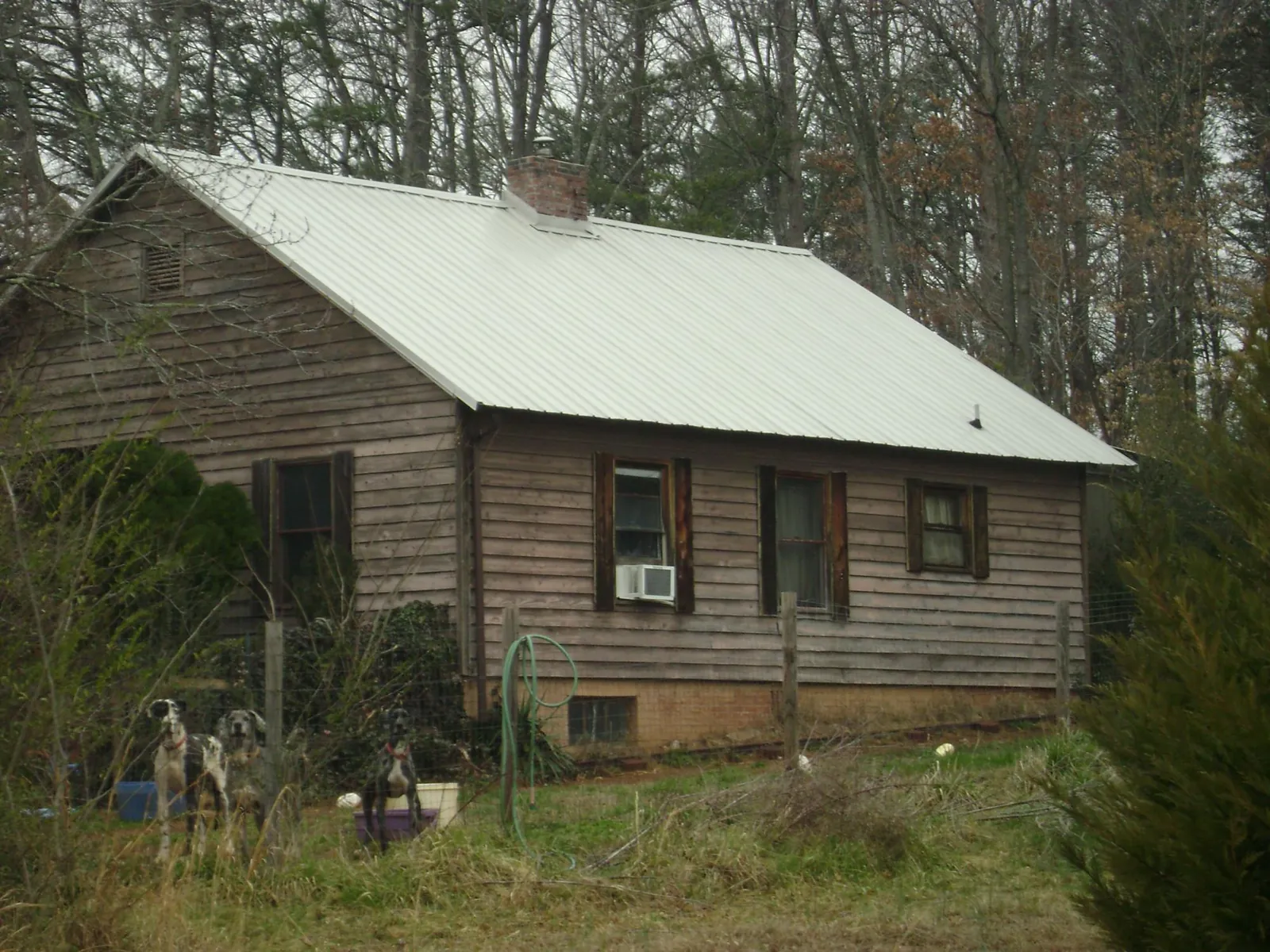White metal roof on an old wood sided farmhouse, from a Metal Roof Installation job in Hailey